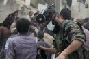 A man searches for survivors from the rubble of a damaged area in Al-Sukkari neighborhood in Aleppo