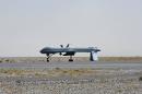 A US Predator unmanned drone armed with a missile stands on the tarmac of Kandahar military airport on June 13, 2010