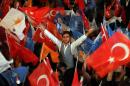 Supporters of President Recep Tayyip Erdogan's Justice and Development Party (AKP) wave flags after results of legislative elections in Ankara on June 7, 2015