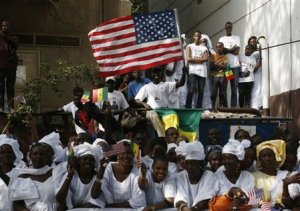 Senegalese watch as U.S. President Obama's motorcade …