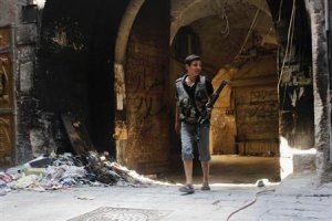 A young Free Syrian Army fighter is seen with his weapon …