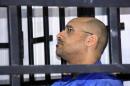 Saif al-Islam Gaddafi, son of late Libyan leader Muammar Gaddafi, attends a hearing behind bars in a courtroom in Zintan