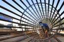A worker welds steel bars at a construction site for a new train station in Ningbo