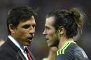 Wales coach Chris Coleman (L) consoles forward Gareth Bale after Wales lost to Portugal 2-0 in the Euro 2016 semi-final on July 6, 2016