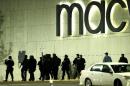 Officials wearing tactical gear walk outside of Garden State Plaza Mall following reports of a shooter, Monday, Nov. 4, 2013, in Paramus, N.J. Hundreds of law enforcement officers converged on the mall Monday night after witnesses said multiple shots were fired there. (AP Photo/Julio Cortez)