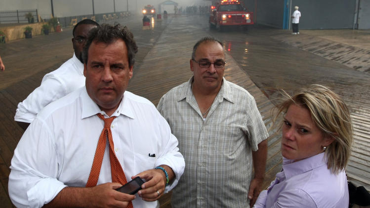 In this Sept. 12, 2013 photo provided by the Office of the Governor of New Jersey, Deputy Chief of Staff Bridget Anne Kelly, right, stands with Gov. Chris Christie, left, during a tour of the Seaside Heights, N.J. boardwalk after it was hit by a massive fire. Christie fired Kelly Thursday, Jan. 9, 2014, and apologized over and over for his staff's "stupid" behavior, insisting during a nearly two-hour news conference that he had no idea anyone around him had engineered traffic jams as part of a political vendetta against a Democratic mayor. (AP Photo/Office of Gov. Chris Christie, Tim Larsen)