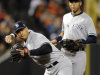 New York Yankees third baseman Alex Rodriguez, front, fields a ground ball by Baltimore Orioles' Matt Wieters in front of shortstop Derek Jeter in the second inning of Game 2 of the American League division baseball series on Monday, Oct. 8, 2012, in Baltimore. (AP Photo/Nick Wass)