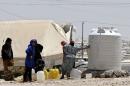 Syrian refugees collect water at the Al-Zaatari refugee camp in Mafraq