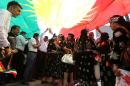Iraqi Kurdish protesters deploy a giant flag of their autonomous Kurdistan region during a demonstration to claim for its independence on July 3, 2014 outside the Kurdistan parliament building in Arbil, in northern Iraq