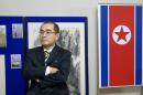 North Korea's deputy ambassador to the UK, Thae Yong-ho, stands in front of an artwork during an exhibition of North Korean artists, at the N. Korean embassy in west London, in November 2014