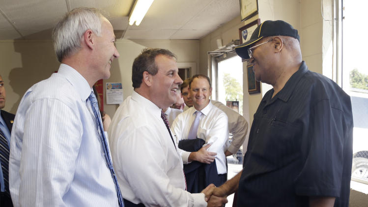Republican candidate for Arkansas governor Asa Hutchinson, far left, watches as New Jersey Gov. Chris Christie, second from left, campaigns for Hutchinson at Lindsey’s Barbecue in North Little Rock, Ark., Wednesday, Aug. 27, 2014. (AP Photo/Danny Johnston)