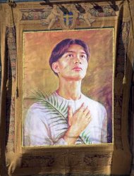A poster depicting Pedro Calungsod hangs on the facade of St. Peter's square at the Vatican during the ceremony of beatification of 44 martyrs led by Pope John Paul II, Sunday, March 5 2000. The Pontiff proclaimed the beatification of Pedro Calungsod, a Filipino who was killed at the age of 17 during a 1672 expedition by Spanish Jesuit missionaries on Guam. (AP Photo/Massimo Sambucetti)