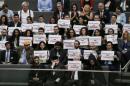 Members of the Armenian community hold up signs during German parliamentary debate on resolution that labels 1915 massacre of Armenians by Ottoman forces as genocide in Berlin