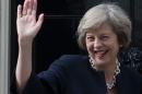 Britain's new Prime Minister Theresa May waves outside 10 Downing Street in central London on July 13, 2016 on the day she takes office following the formal resignation of David Cameron