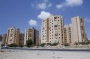 A car drives past an unfinished residential block in the Libyan capital Tripoli