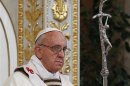 Pope Francis holds a cross as he leads a solemn mass at Saint Paul's Basilica in Rome