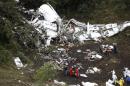 FILE - In this Nov. 29, 2016 file photo, rescue workers recover a body from the wreckage site of the LaMia chartered airplane crash, in La Union, a mountainous area near Medellin, Colombia. In a Monday, Dec. 26, 2016 statement, Colombian aviation authorities say a preliminary investigation has found that the plane that crashed just outside of Medellin with a Brazilian soccer team aboard had run out of fuel. Civil Aeronautics agency says the conclusion is based on the plane's black boxes and other evidence. (AP Photo/Fernando Vergara, File)