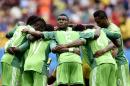 Nigeria's Emmanuel Emenike, center, looks up as his team form a huddle before the start of the second half during the World Cup round of 16 soccer match between France and Nigeria at the Estadio Nacional in Brasilia, Brazil, Monday, June 30, 2014. (AP Photo/Martin Meissner)