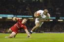 England's Jonathan Joseph, right, avoids a tackle by Wales' George North as he heads over to score during their 6 Nations Championship Rugby match at the Millennium Stadium, Cardiff, Friday Feb. 6, 2015. (AP Photo/Jon Super)