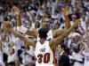Miami Heat's Chris Bosh and Norris Cole (30) celebrate after the Heat defeated the Chicago Bulls 94-91 in Game 5 of an NBA basketball Eastern Conference semifinal, Wednesday, May 15, 2013, in Miami. The win sent the Heat to the conference finals. (AP Photo/Wilfredo Lee)