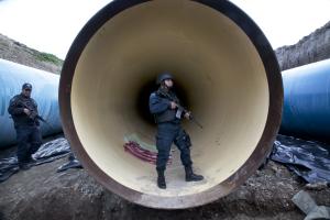 Federal police guard a drainage pipe outside of the&nbsp;&hellip;