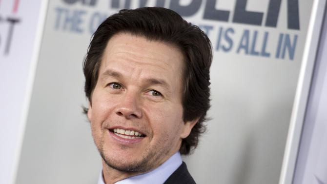 FILE - In this Nov. 10, 2014, file photo, Mark Wahlberg arrives at the 2014 AFI Fest - "The Gambler," in Los Angeles. Wahlberg asked Massachusetts for a pardon for assaults he committed in 1988 when he was a teenager in Boston. Wahlberg’s application with the Massachusetts Parole Board said he isn’t the same person he was 26 years ago and his past convictions are still affecting his life. Victims of one of Mark Wahlberg’s racially motivated attacks as a teenage delinquent in segregated 1980s Boston are divided over whether the actor should get the pardon he’s seeking. (Photo by Richard Shotwell/Invision/AP, File)
