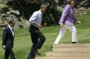 From left, French President Francois Hollande, President Barack Obama and German Chancellor Angela Merkel make their way to a photo opportunity at the G-8 Summit Saturday, May 19, 2012 at Camp David, Md. (AP Photo/Charles Dharapak)