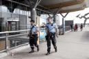 Armed police officers patrol outside a terminal building at Oslo Airport
