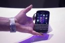 An attendee reaches out to grab a newly launched RIM Blackberry 10 device in New York