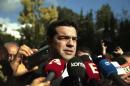 Tsipras, opposition leader and head of radical leftist Syriza party, talks to reporters outside the parliament building after the last round of a presidential vote in Athens
