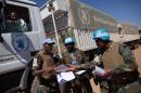 A handout picture taken on February 10, 2014 and released by the United Nations-African Union Mission in Darfur (UNAMID) shows UNAMID officers exchanging duties in Tabit, North Darfur