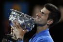 Novak Djokovic of Serbia holds the trophy after defeating Andy Murray of Britain in the men's singles final at the Australian Open tennis championship in Melbourne, Australia, Sunday, Feb. 1, 2015. (AP Photo/Vincent Thian)