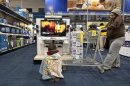 A boy watches television at a Best Buy store in Pineville, North Carolina