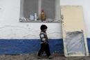 A Roma child walks in a camp in the Serb-majority town of Leposavic in northern Kosovo on December 16, 2013