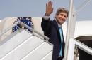 US Secretary of State John Kerry waves as he boards a plane from Paris on March 31, 2014 for a trip to the Middle East to work on talks about the Middle East peace process