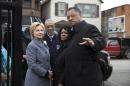 Democratic presidential candidate Hillary Clinton, is greeted by Rev. Jesse Jackson, right, Diane Latiker of Kids off the Block memorial, second from right, and Rep Bobby Rush, D-Ill., as she arrives to visit Kids off the Block memorial l to children killed by gun violence in Chicago, Monday, March 14, 2016. (AP Photo/Carolyn Kaster)