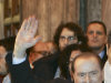 Italian Premier Silvio Berlusconi waives as he leaves at the end of a meeting with his allies in the Italian Senate in Rome, Thursday, Nov. 10, 2011.  Arriving earlier at the Senate, where the budget committee approved the reforms Thursday evening, Berlusconi was heckled by some 20 bystanders. The prospect of an Italian government led by leading economist Mario Monti, after Berlusconi pledged to resign soon,  helped calm market jitters Thursday that the country was heading for a Greek-style economic crisis that would threaten the very existence of the euro currency itself.  (AP Photo/Riccardo De Luca)