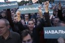 People hold banners reading "Navalny" during a rally in support of Russian opposition leader Alexei Navalny in Moscow, Russia, Monday, Sept. 9, 2013. Russian opposition leader Alexei Navalny demanded a recount Monday in Moscow's mayoral election after official results showed that the Kremlin-backed incumbent barely escaped facing him in a runoff. Russia's most respected monitoring group also questioned the accuracy of the vote. (AP Photo/Ivan Sekretarev)