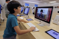 <p>               In this  Thursday, July 19, 2012, photo an Apple customer Shayan Hooshmand, 11, uses PhotoBooth on a 21.5-inch iMac at an Apple store in Palo Alto, Calif. Apple Inc. reports quarterly financial results after the market closes on Tuesday, July 24. (AP Photo/Paul Sakuma)