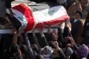 Iraqi Shiite mourners carry the coffin of a soldier killed the previous day in Diyala, during his funeral procession in Najaf on February 19, 2014