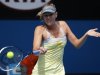 Maria Sharapova of Russia hits a return to compatriot Olga Puchkova during their women's singles match at the Australian Open tennis tournament in Melbourne