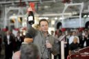 Tesla Chief Executive Office Elon Musk celebrates at his company's factory in Fremont