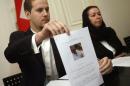 Daniel Levinson (L) shows a picture of his missing father, ex-FBI agent Robert Levinson, during a press conference at the Swiss embassy in Tehran, Iran, on December 22, 2007