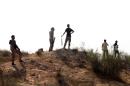 Fighters of Libya's Fajr Libya (Libyan Dawn) hold a position their group took from a rival militia, south of the town of Wershfana on October 13, 2014, some 30 kilometres west of the Libyan capital Tripoli