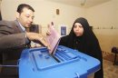 An Iraqi policewoman casts her vote at a polling station in Kerbala