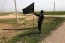 A member of an islamist group holds a flag in Raqqa province