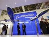Visitors chat in front of Boeing plane models at China International Aviation & Aeropsace Exhibition in Zhuhai