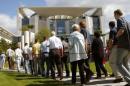 Visitors walk in front of the Chancellory during the second day of an open door weekend of several ...