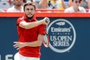 Gilles Simon of France hits a return against Andreas Seppi of Italy during day one of the Rogers Cup on August 10, 2015 in Montreal