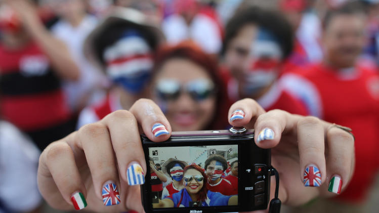 Costa Rica soccer fans pose for a selfie before they watch their team&#39;s World Cup round of 16 match against Greece on a live telecast inside the FIFA Fan Fest area on Copacabana beach in Rio de Janeiro, Brazil, Sunday, June 29, 2014. (AP Photo/Leo Correa)